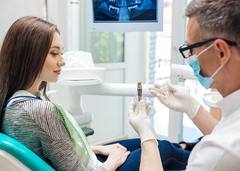 a dentist and patient talking about dental implants