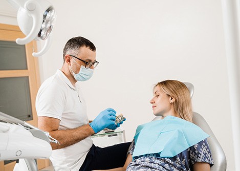 Woman listening to her dentist during All-on-4 consultation