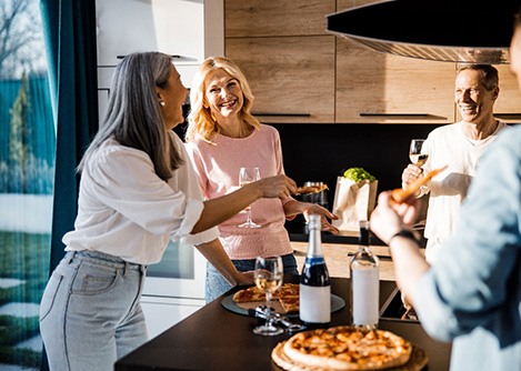 Middle-aged friends enjoying a meal together