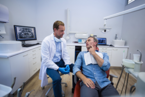 a patient speaking with an oral surgeon 