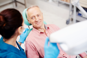 a senior patient talking with his oral surgeon