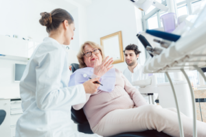 a patient chatting with their oral surgeon